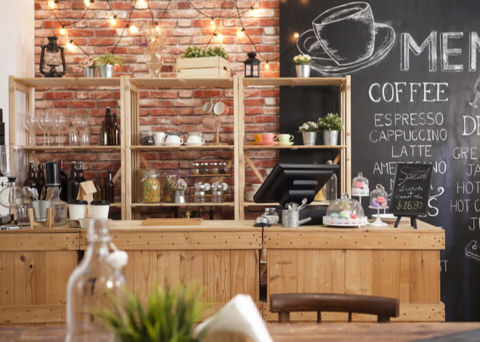 a coffee shop with a chalkboard wall behind it.